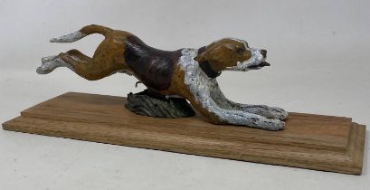 A cold painted bronze desk clip figure of a hound, on a wooden base, 28 cm wide Condition good, a