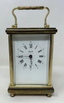 A carriage clock, in a brass and glass case, 56 cm high