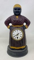 A novelty clock, in the form of a woman, in a painted metal case, 31 cm high Condition good, a