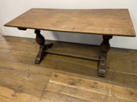 An oak refectory style dining table, on bulbous supports united by a stretcher, 150 cm wide