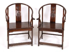 A pair of Chinese hardwood chairs, the backs carved with bat and fish (2) Overall condition good