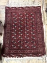 An Afghan type red ground rug, the centre with multiple repeating medallions, 167 x 120 cm