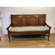 A George III oak settle, with a four panel back and cabriole front legs A good colour Depth - 59