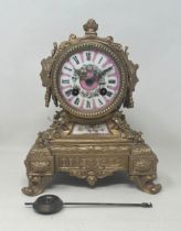 A mantel clock, with a porcelain dial, with a twin train 8 day movement, in a gilt metal case, 20 cm