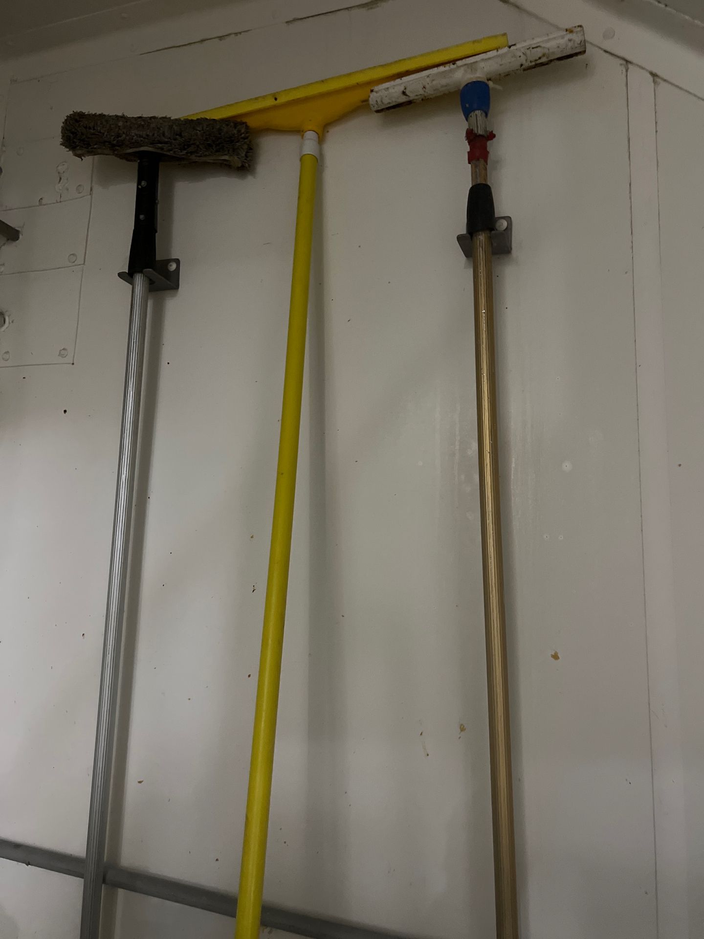 Lot of (3) Cleaning tools incl. Squeegee and two brooms with rack