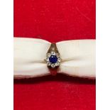 A 9 carat yellow gold cluster ring set with sapphire and clear stones, size N, 2.4 grams