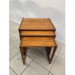 A mid century nest of coffee tables