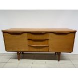 A mid century teak sideboard with 3 central drawers, unknown maker. Scuffs, scratches and rings to