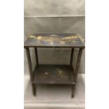 A small chinoiserie black lacquered side table on brass casters, 60cm high