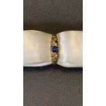 An 18 carat yellow gold ring set with sapphire and diamond, 2.7 grams, size O