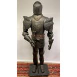 A replica tin plate suit of armour with sword standing 177cm high on a wooden plinth