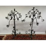A pair of wrought iron church candle holders, each holds 23 candles 137 cm high