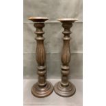 A pair of decorative wooden candlesticks 75cm high