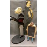 A vintage plastic card holder in the image of a butler 83cm high, a wooden cut out waiter 98cm