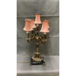 A vintage brass ormolu lamp on a marble base