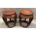 A well carved pair of Chinese drum shaped hard wood stools, 19th or 20th century