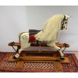 A vintage medium sized dappled white carved wooden rocking horse
