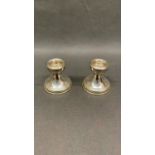 A pair of silver candlesticks with weighted bottoms, 198 grams