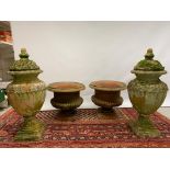A pair of weathered terracotta planters and a pair of weathered terracotta lidded urns Planters 44cm