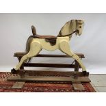 A medium sized vintage wooden rocking horse. 122cm long x 110cm high