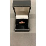 A 9 carat yellow gold ring set with diamond and rubies, size O. 2 grams