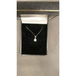 A 9 carat white gold chain and pendant, set with diamond cluster. 1.3 grams