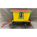 A rare antique toy gypsy caravan with cast iron wheels, measures 54cm long and 53cm high