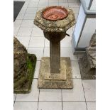 A vintage concrete bird bath / garden fountain