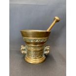 A mid 17th century brass pestle and mortar marked with the letters God T Van, 14cm wide and 14cm
