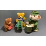 A Carl original wind up bear with drum along with a vintage battery operated drumming bear and a