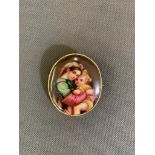 An antique hand painted miniature of mother and child on porcelain, in a gold frame, tests 9 carat