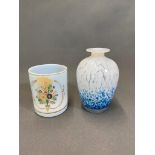 A splash blue and white vase and an opaque glass cup