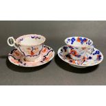 Pair of well decorated cups and saucers, predominantly red and blue