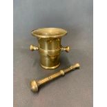 A small 17th century brass pestle and mortar 10 cm high x 9 cm wide