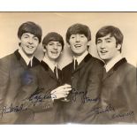 A printed Beatles Photograph of the Fab Four, autographs are printed on. Given to the seller's