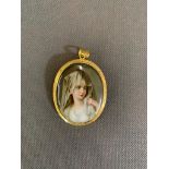 A hand painted miniature on porcelain of veiled lady in base metal frame