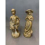 A pair of antique solid brass figurines of a boy and a girl