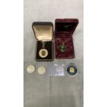 2 enamel necklace coins along with 2 1995 £2 coins a Battle of Britain 50p and a Gibraltar 1967