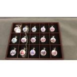 A collection of 31 pocket watches with Steam locomotive images on front of cases in 2 display