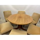An extending Nathan dining table with 6 upholstered chairs