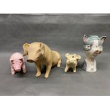 4 x pig figures, a large antique ceramic butchers shop piggy bank, a solid cast iron butchers shop