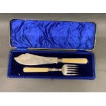 A solid silver antique fish knife and fork set with bone handles