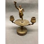 A bronze cast candle holder with a figure of Bacchus (ancient God of wine and festivity) 25 cm high