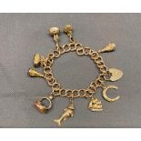 A 9 Carat gold charm bracelet with 6 collectible seals attached, 36.8 grams