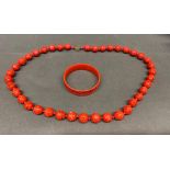 A Cinnabar necklace and bangle