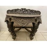 A very good heavily carved Indonesian console table on 4 scrolled legs , 125cm wide and table top is