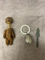 An Antique monkey perfume bottle, an antique white metal babies rattle and teething ring together