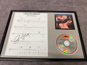 A framed singed song sheet of â€œ I shot the sheriff â€œ by Eric Clapton. Frame size 44 x 32cm