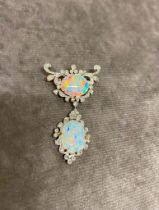 A double opal brooch with diamond surround and set in 18 carat gold, possibly made in the 1920s. The