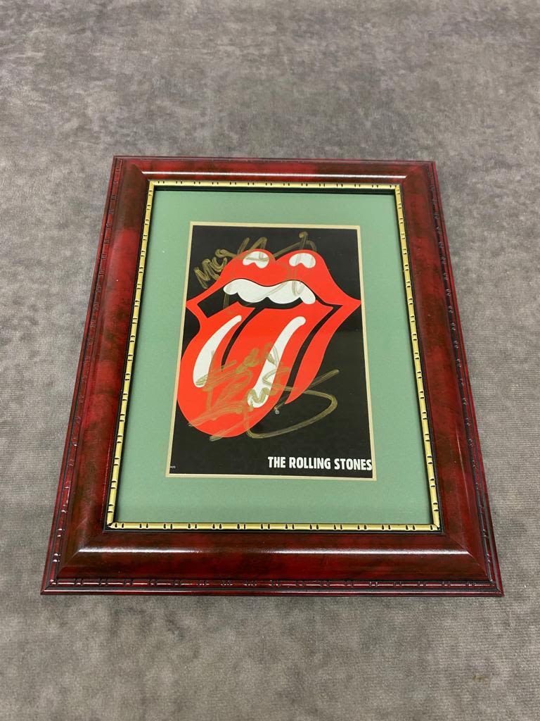A framed Rolling Stones tongue singed by Mick Jagger and Keith Richards. Frame size 20cm x 25cm